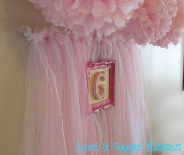 Party backdrop in pink tulle, like a tutu. 