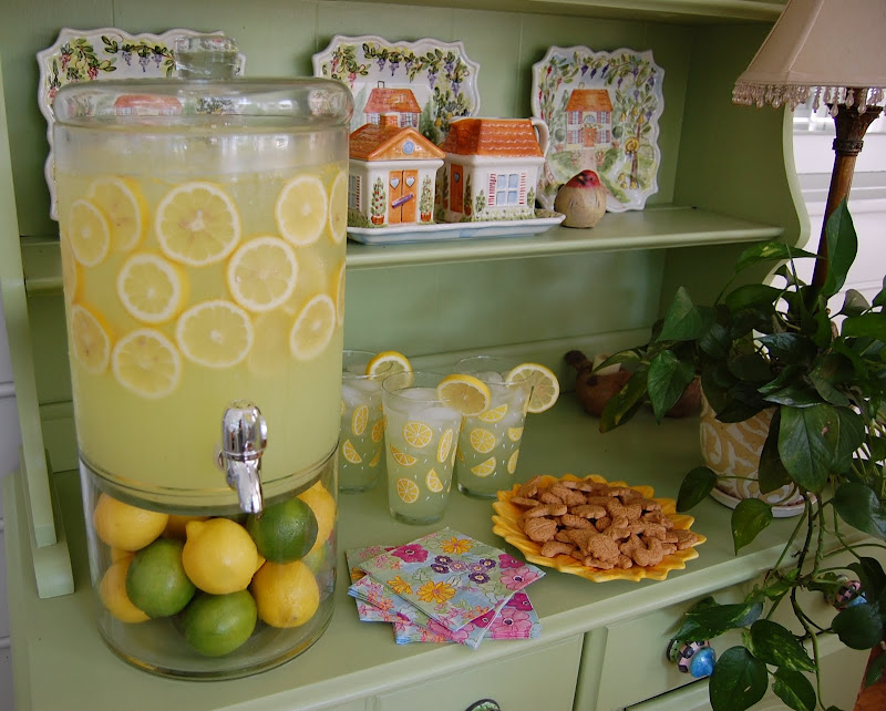 Beverage dispenser for serving lemonade or limeade, with sliced lemons in the lemonade.