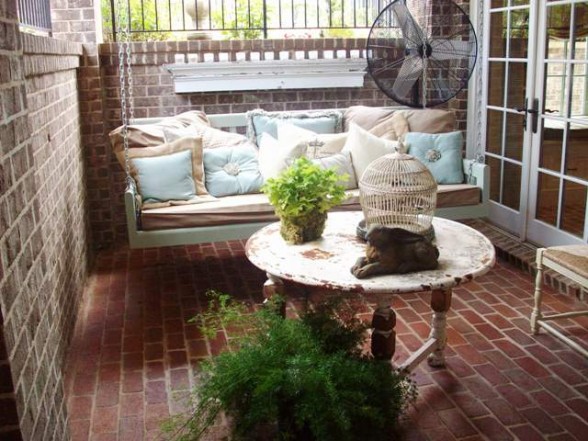 Shabby chic porch swing all comfy with pillows.