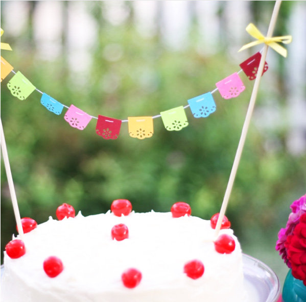 Tiny fiesta bunting, garland or banner on a cake for a party