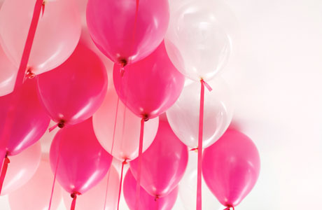 Pink and white balloons tied with contrasting ribbons and floated 
