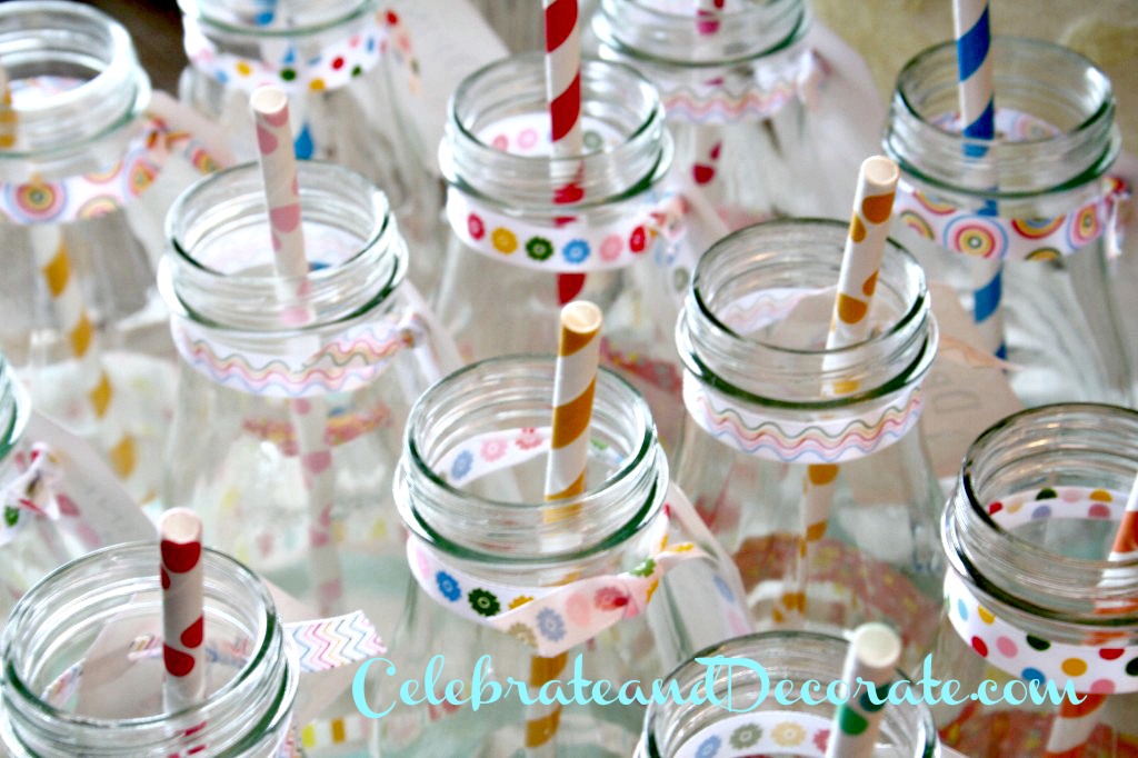 Bottles decorated with washi tape and polka dot straws.