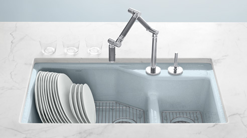 Modern kitchen sink by kohler in enameled cast iron with pale blue color and modern faucet
