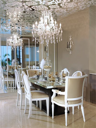 Glamourous dining room with wallpapered ceiling and crystal chandelier