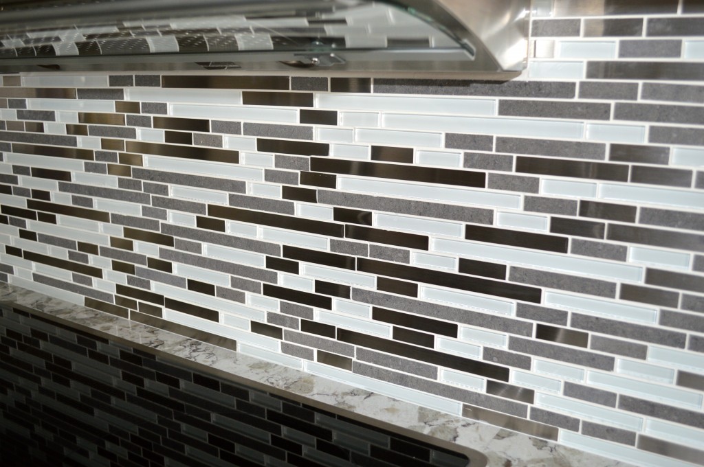 Gray, white, stainless and glass tile backsplash