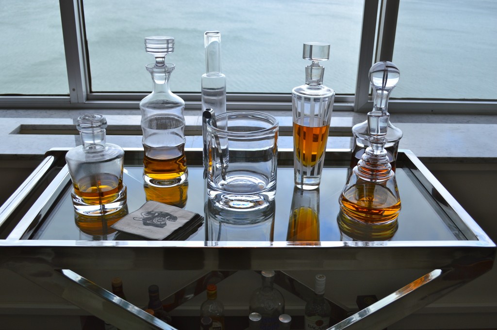 Scotch in decanters on a bar cart.