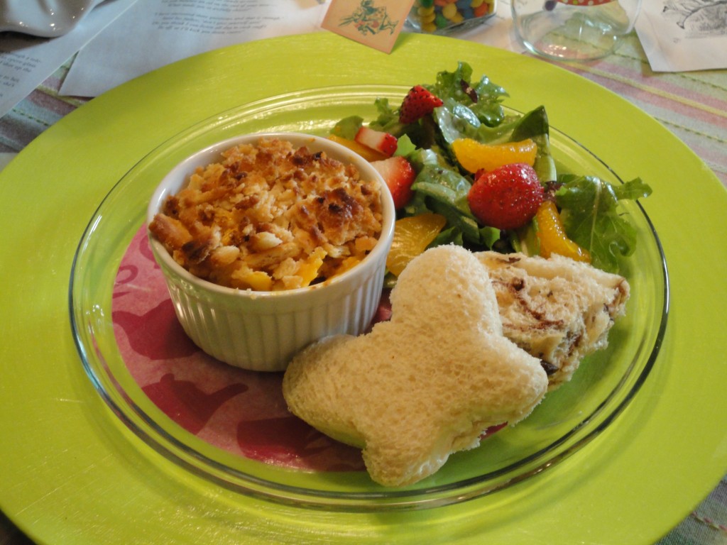 Alice in Wonderland Party Foods mini macaroni and cheese casseroles, butterfly shaped finger sandwiches served alongside salad with strawberries and mandarin oranges
