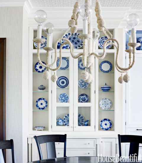 Blue and white dishes in a white hutch