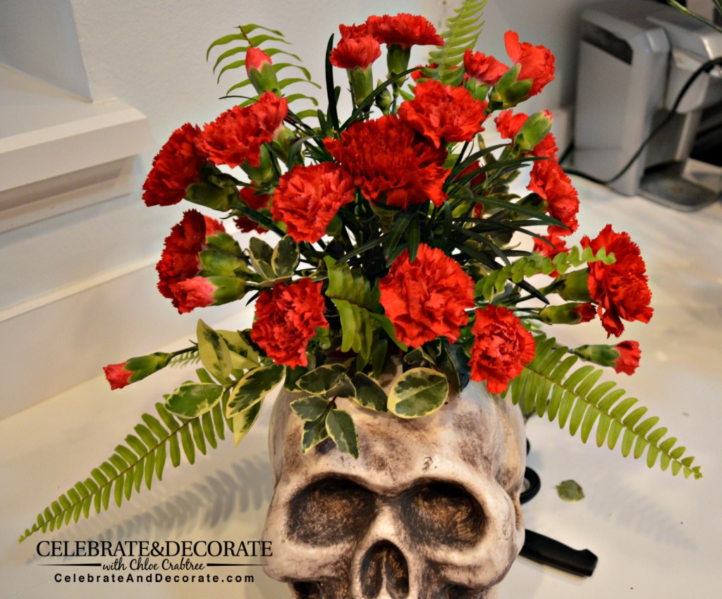 Red miniature carnations arranged in a skull