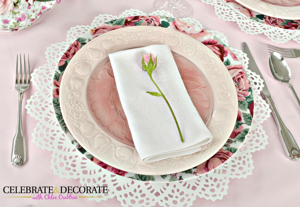 A single rose on each napkin for a Mother's Day tablescape