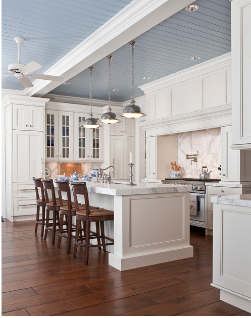 White kitchen with a blue ceiling. 
