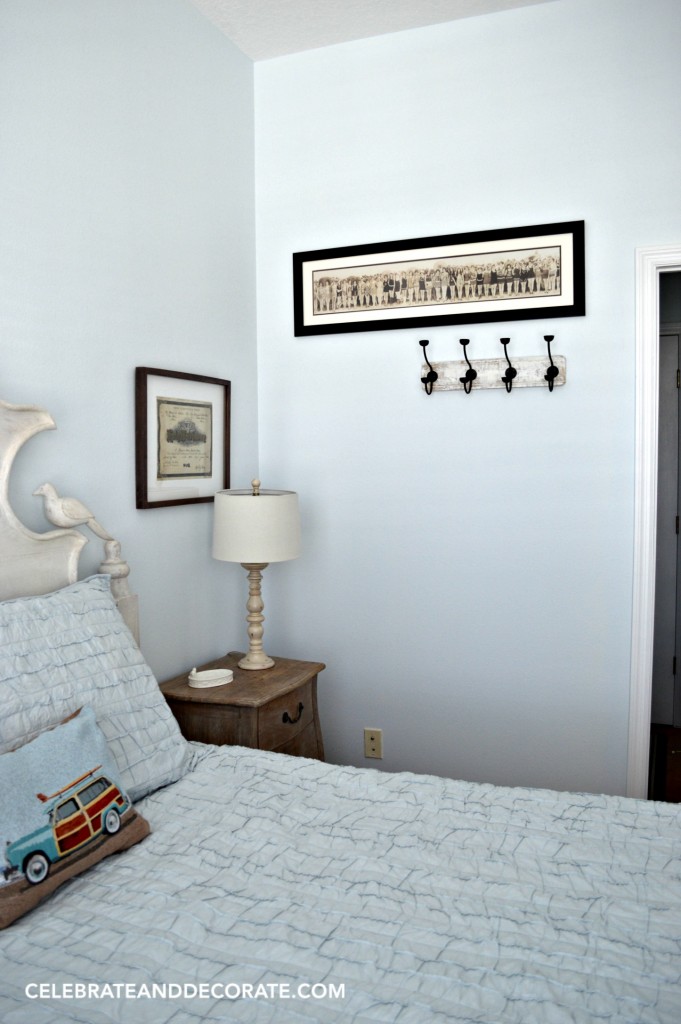 A blue cottage guestroom with vintage photos