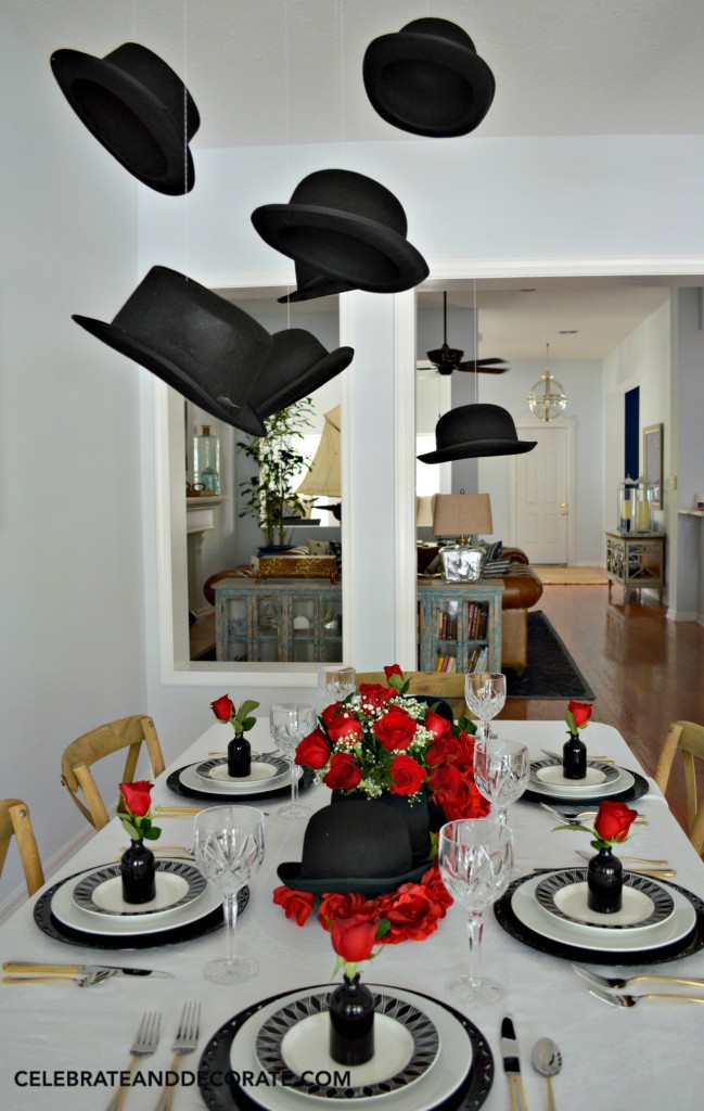 Derbys and Top Hats hang above a table celebrating the graduate with Hat's Off To You