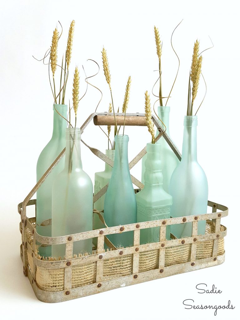 9_vintage_milk_bottle_carrier_basket_repurposed_as_coastal_beach_decor_centerpiece_with_DIY_sea_glass_bottles_Sadie_Seasongoods