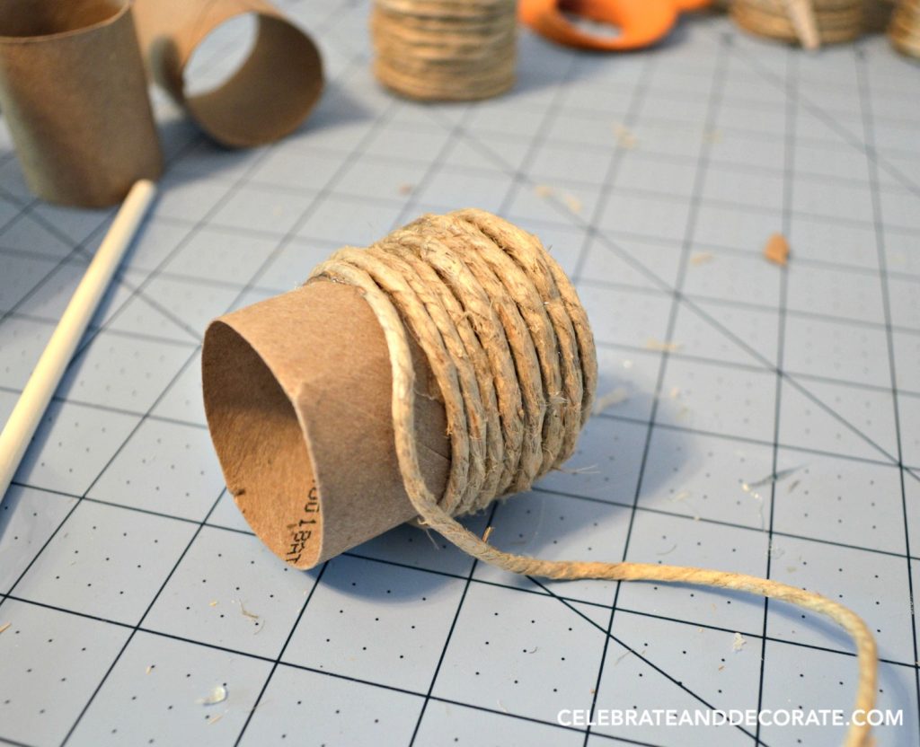 A cardboard tube wrapped with twine.