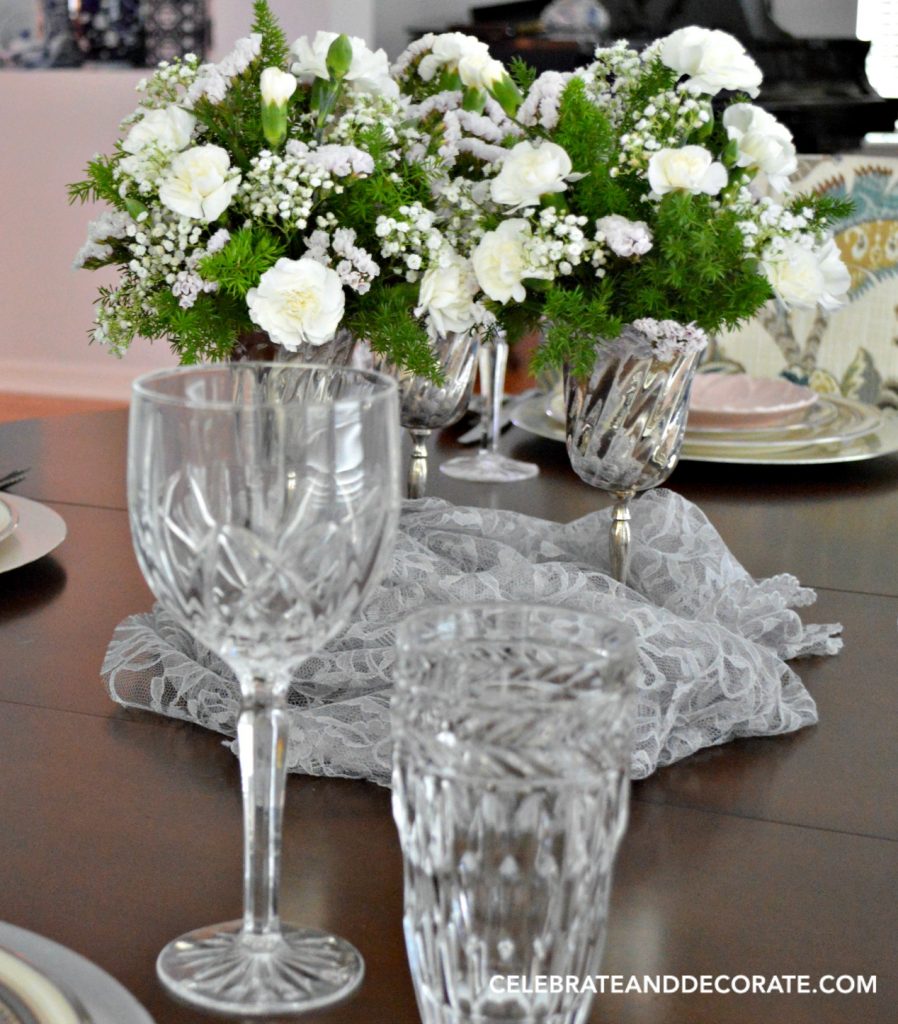 White flowers in silver goblets