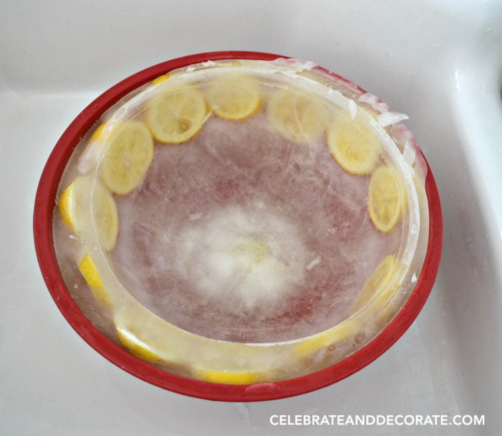 Ice bowl with lemon slices suspended in it ready to display seafood