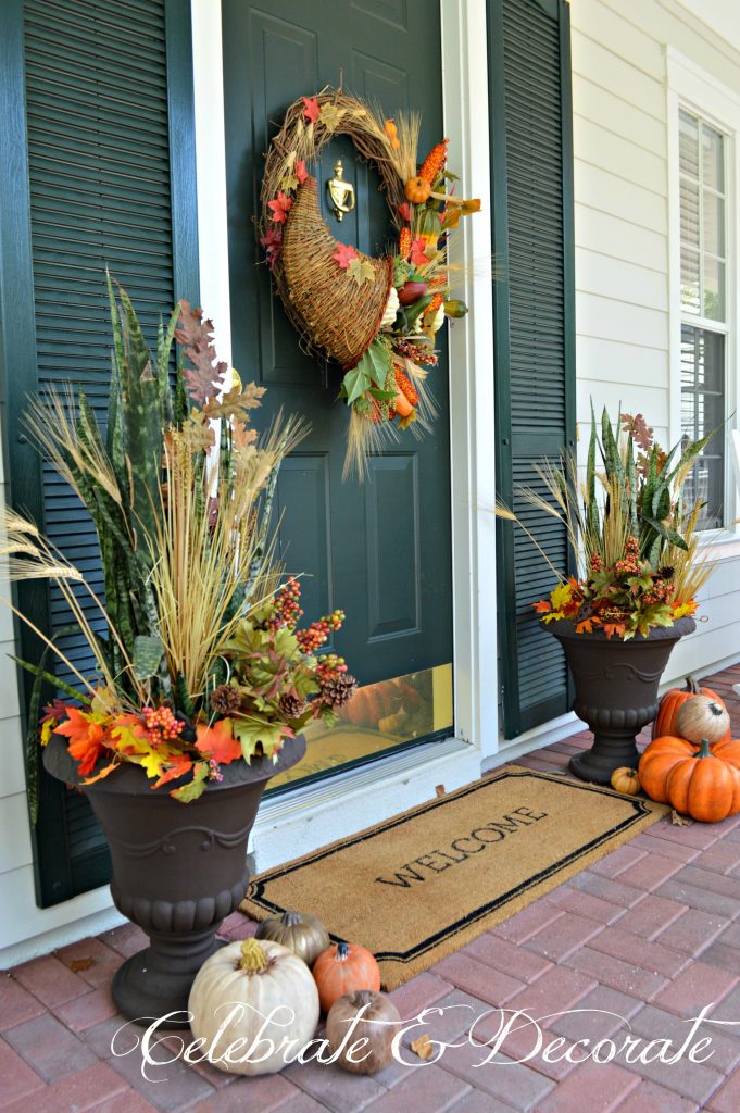 A Cornucopia wreath graces this pretty front porch decorated for Fall