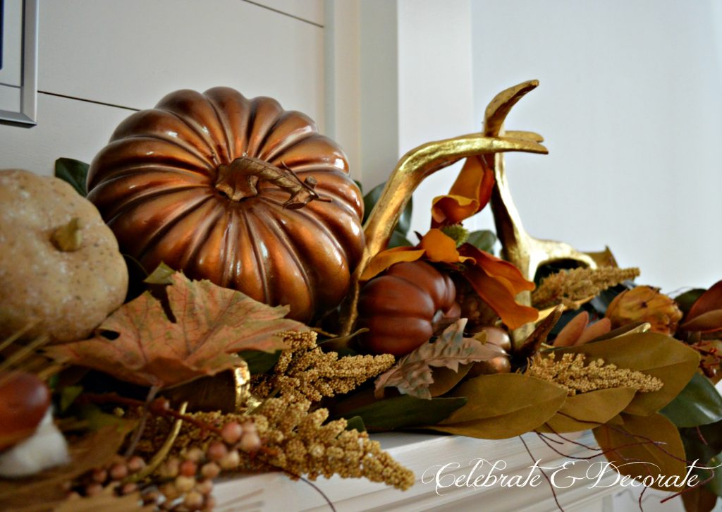 A Fall mantel decorated in gold and brown.