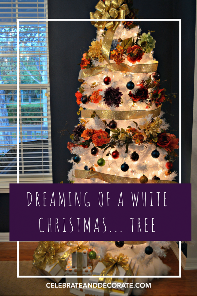 A White Christmas tree decorated with garlands of jewel tone flowers. 