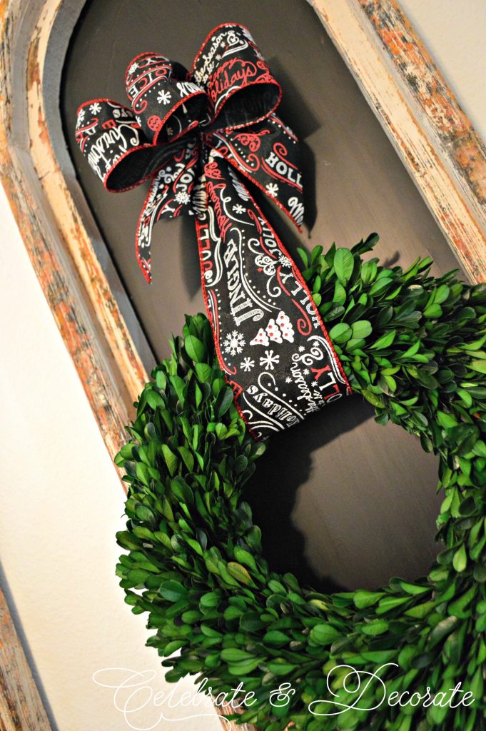 Boxwood wreath tied with chalkboard ribbon for Christmas