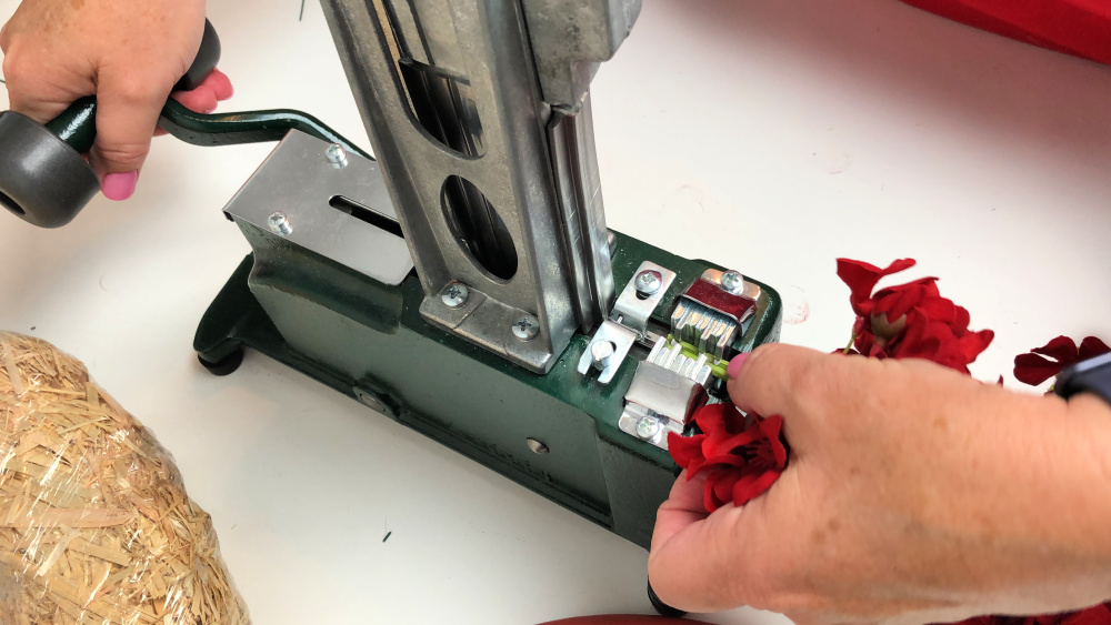 Using a steel pick machine to attach pick onto red blooms