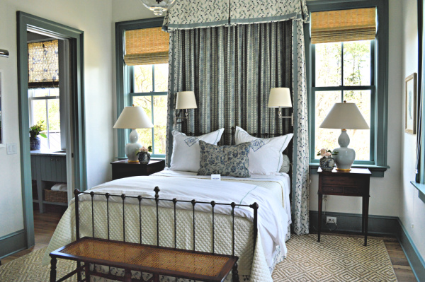 A southern bedroom with a faux canopy is ready to welcome guests with blue accents and matchstick blinds.