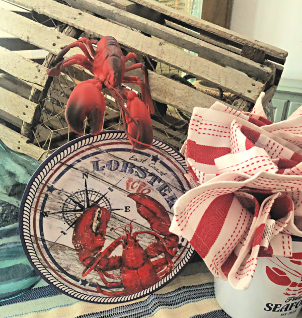 Vintage looking melamine dinner plates with a lobster on them and a lobster trap