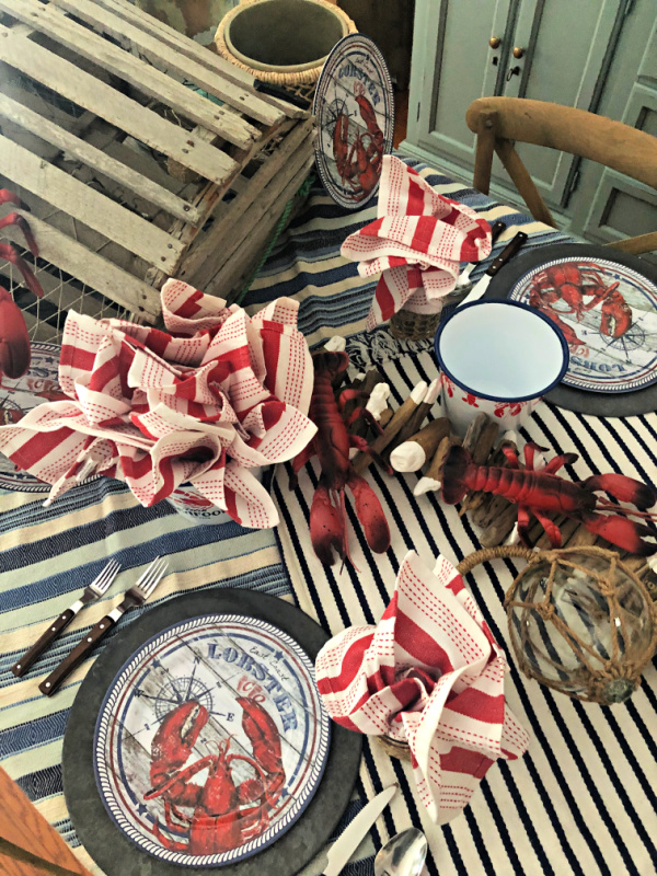 Table set for a seafood party with lots of lobster and coastal accents