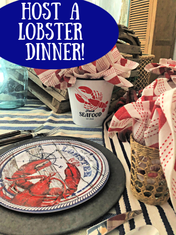 Lobster tablescape with red and shite napkins and lobster printed dinner plates 