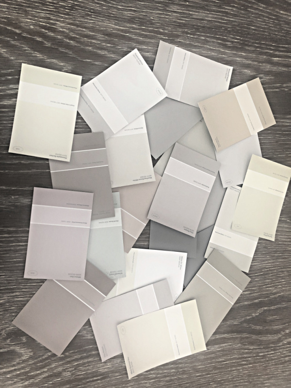 paint swatches in neutral colors spread on a tabletop