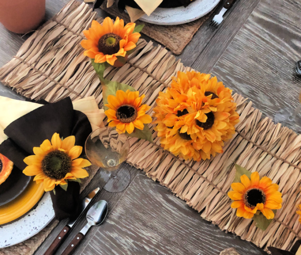 Overhead shot of how to style a table for late summer with sunflower decorations