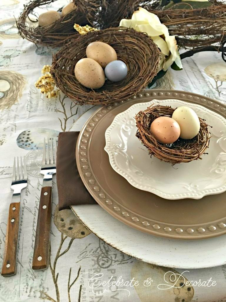 Brown and white tablescape celebrating birds with bird's nests and eggs.