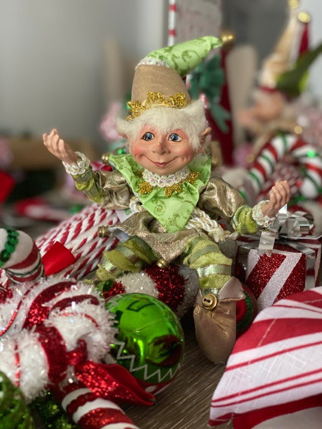 A cute little christmas elf as part of a centerpiece for a holiday table. 