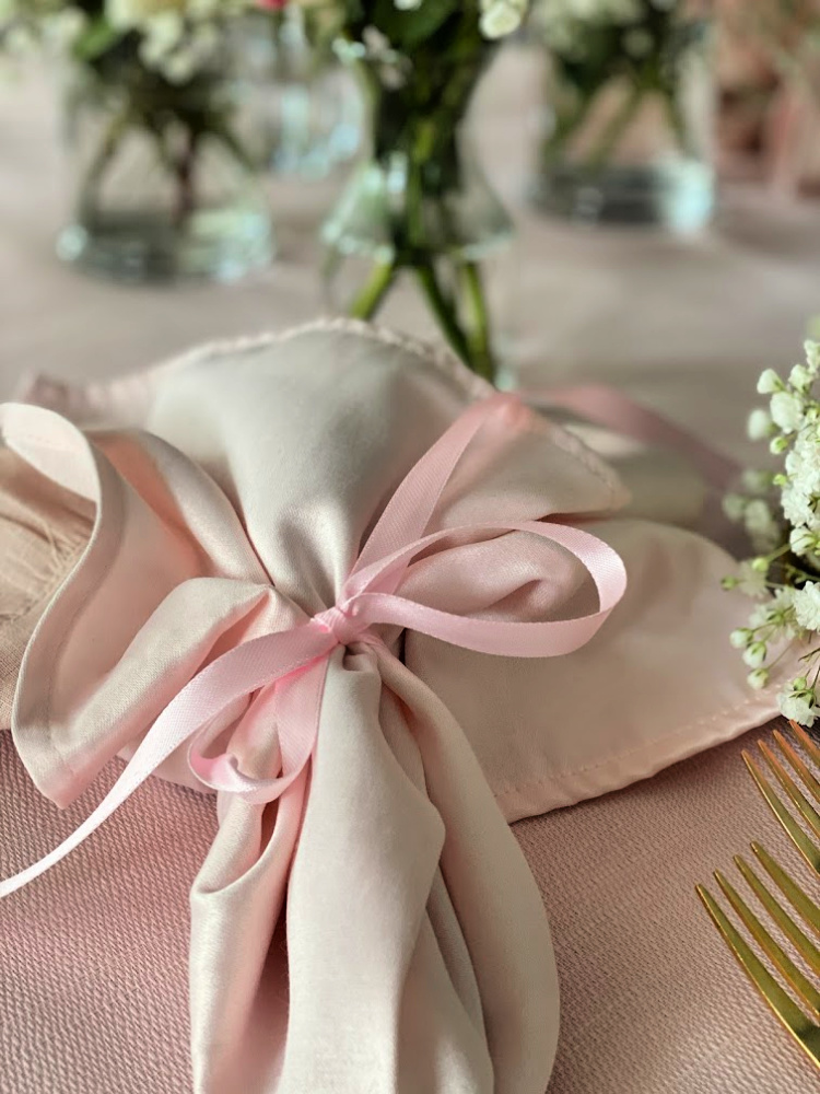 Two pink napkins tied with a pink ribbon.