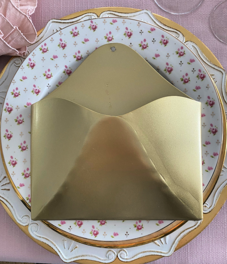 A plate stack with a gold metal envelope on it