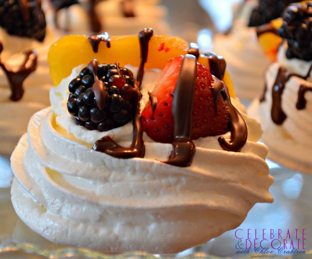 Individual pavlova with berries, peaches and chocolate drizzle