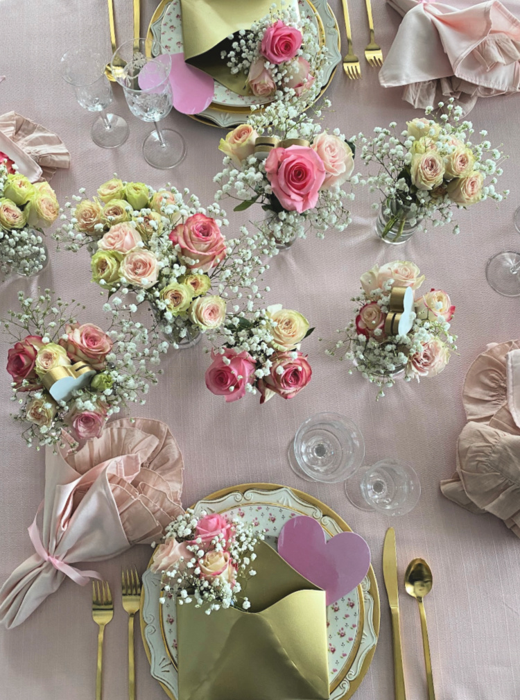 Vases of pink roses on a tabletop