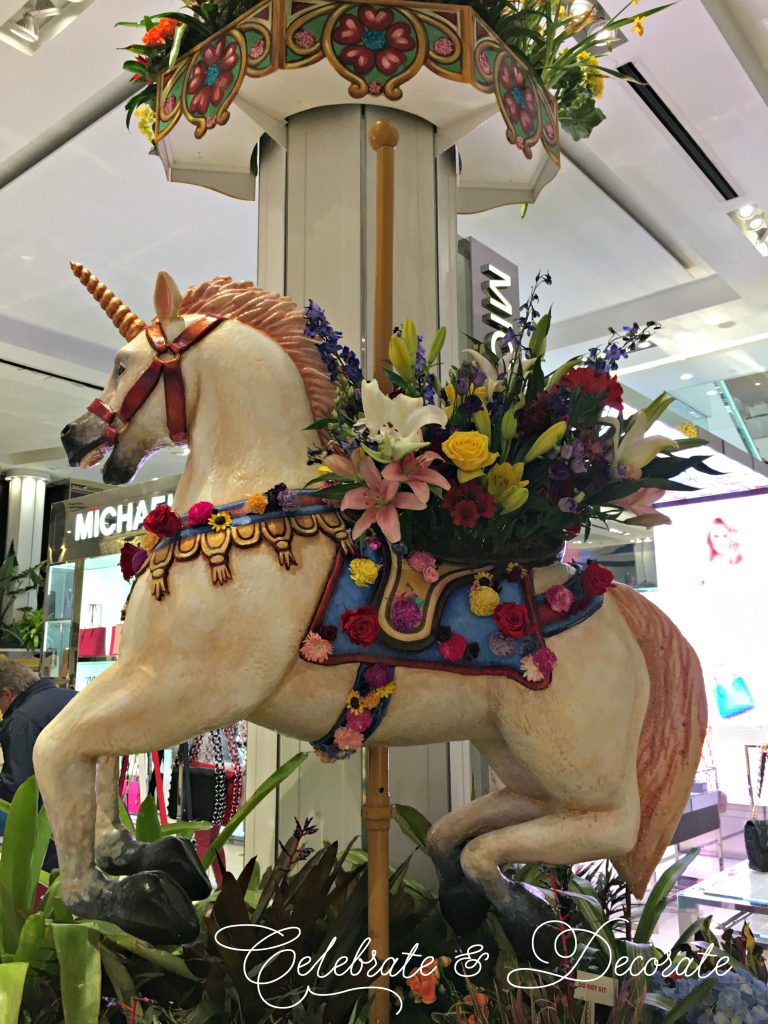 A Carousel Horse decked out with fresh flowers 