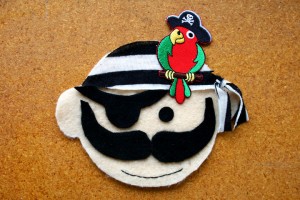 Pirate party invitation made of felt and trimmed with an iron on pirate parrot applique