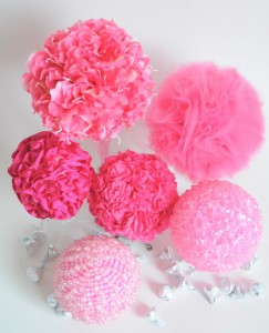 Pink pompons or spheres decorated with different items, beads, paper, fabric, tulle