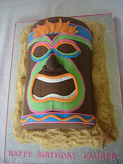 Tiki party cake set on brown sugar to suggest the sand