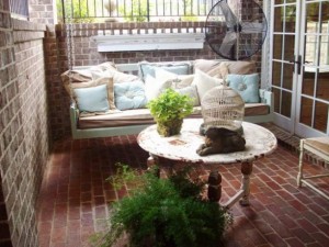 Shabby chic porch swing all comfy with pillows.