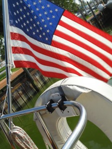 American flag and horseshoe life preserver on the back of the sailboat