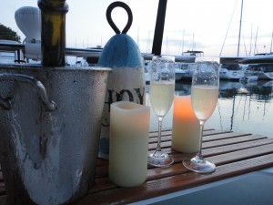 Ahoy! Champagne and candles on the back of the sailboat at sunset.