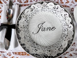 Doily place card set under a clear plate
