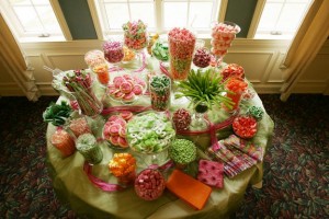 Wedding candy buffet with orange, pink and lime green candies.