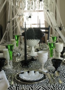 Black and white Halloween table setting with a punch of color from the green potions served in the champagne flutes.