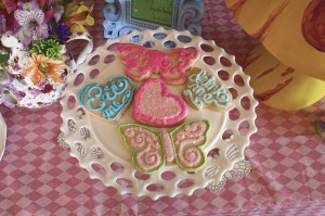 Butterfly, heart, teacup and teapot shaped cookies were offered for an Alice in Wonderland Baby Shower dessert