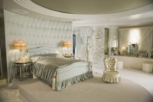 Glamourous bedroom with upholstered walls and victorian lamps